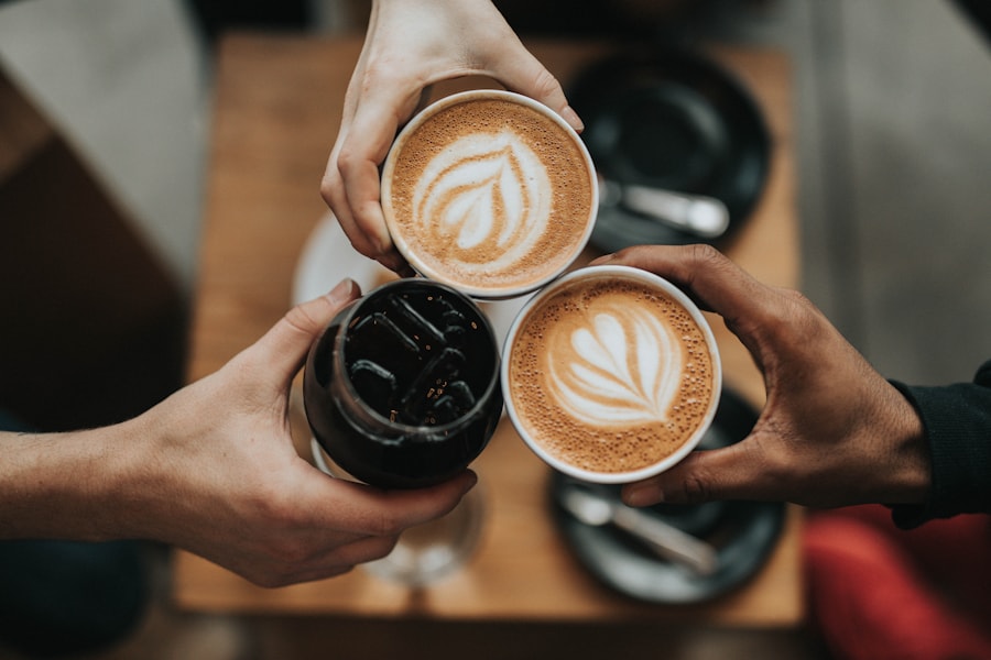 A barista pouring latte art into a cup