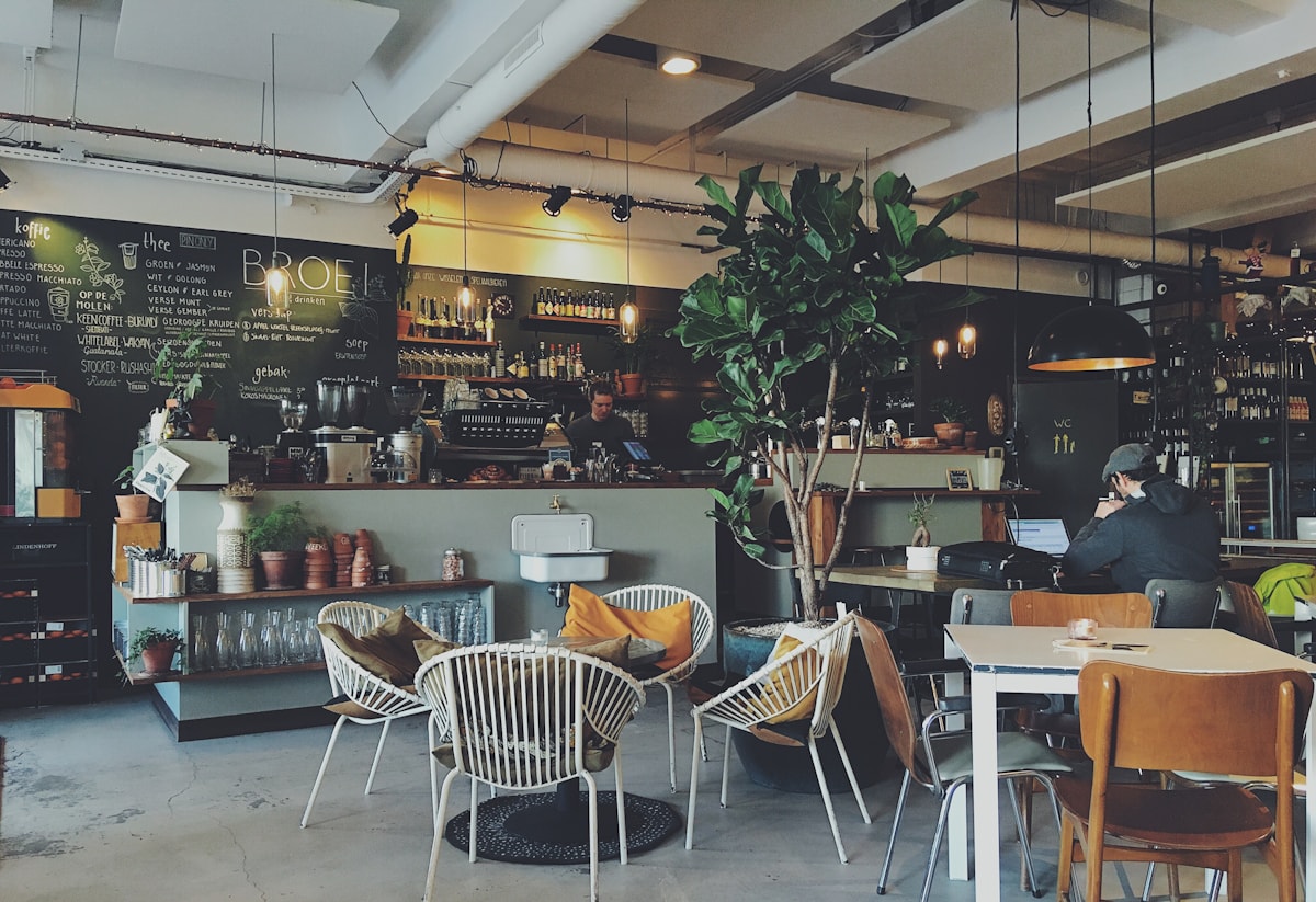 A busy cafe dining room with people sharing tables